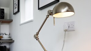 A desk lamp on a wooden desk with a cushioned chair. - The Woden Boutique Hotel Walsall M6 J9 (Wednesbury)