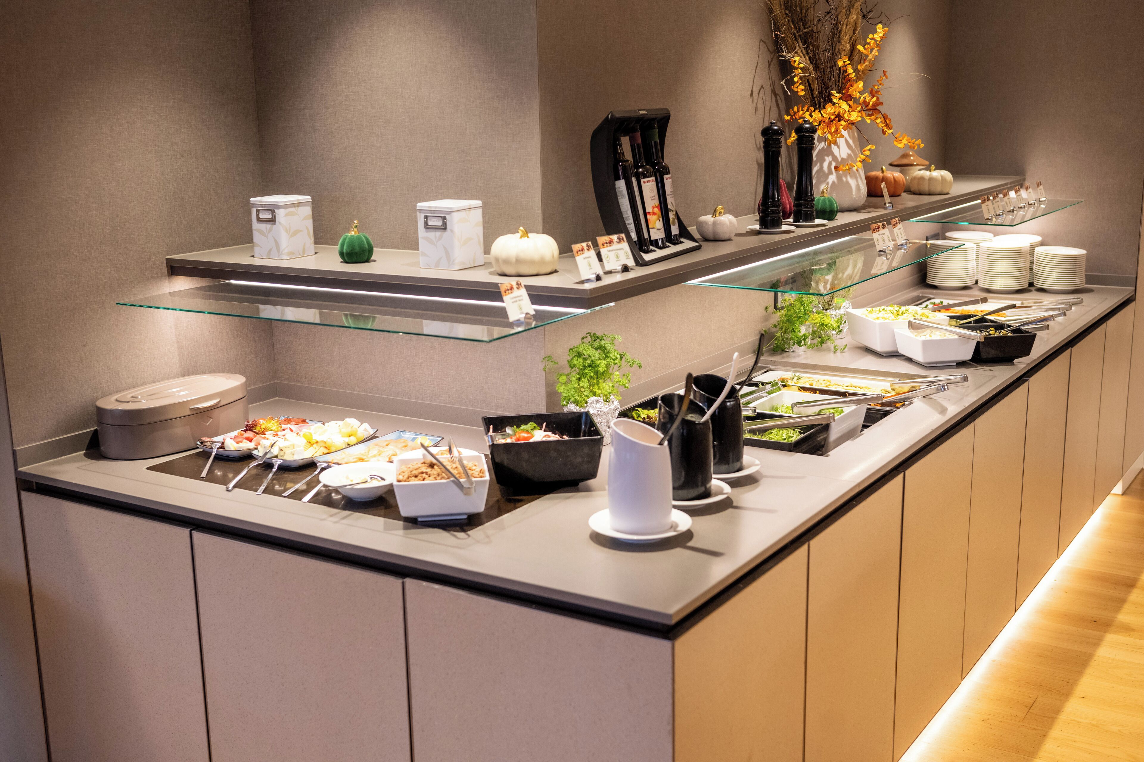 A buffet setup with various food items and condiments.