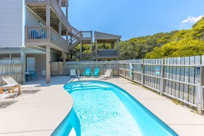 A swimming pool with a wooden deck, outdoor seating, and a fenced area. - Sol Mate - 5BR 2nd Row Home with Ocean Views, Pool, Hot Tub & Pet Friendly! (North Topsail Beach)