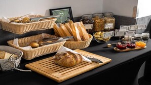 A breakfast buffet with various breads, jams, and spreads. - B&B HOTEL Bytom (Bytom)