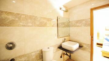 Shower, rainfall showerhead, soap, toilet paper