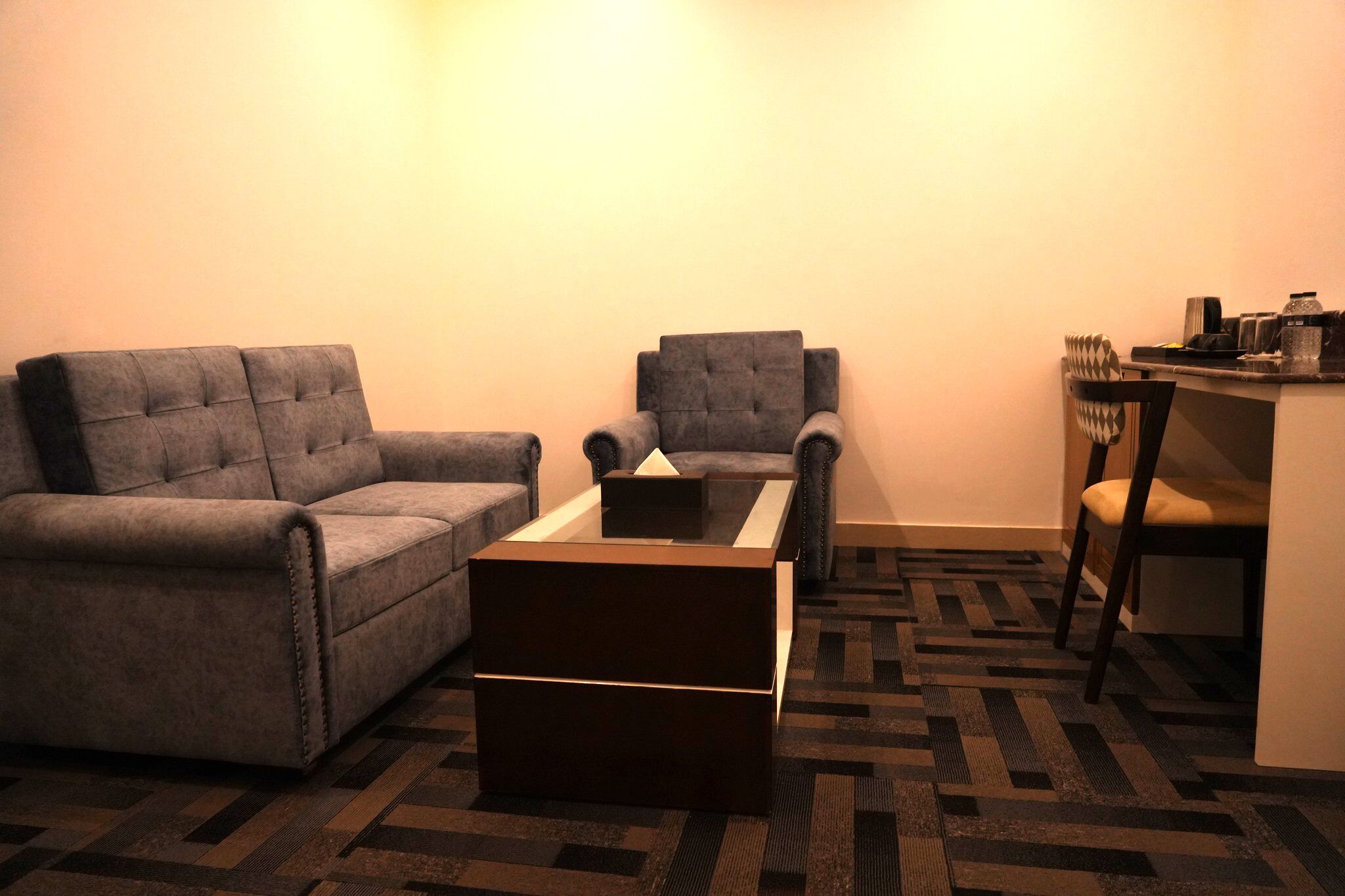 A living room with a sofa, armchair, and a coffee table.