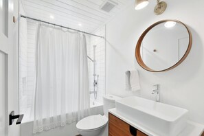 Combined shower/tub, hair dryer, towels, toilet paper