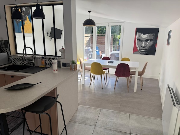 A modern kitchen with a dining area.