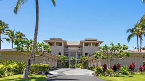 A multi-story building with a central courtyard, surrounded by palm trees and well-maintained lawns. - Hilton Waikoloa pass for 2026. F2 Waikoloa Beach Villas (Waikoloa Beach Resort)