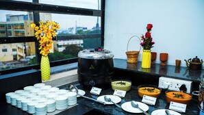 A buffet setup with various dishes and utensils. - Zip By Spree Hotels Bhopal (Bhopal)