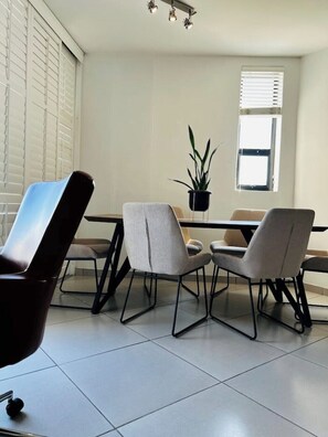 Enjoy meals in this stylish dining area with a rectangular table and four comfortable chairs.