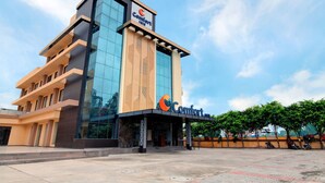 A modern hotel with a prominent 'Comfort Inn' sign, large glass windows, and a structured facade. - Comfort Inn Karnal (Nilokheri)