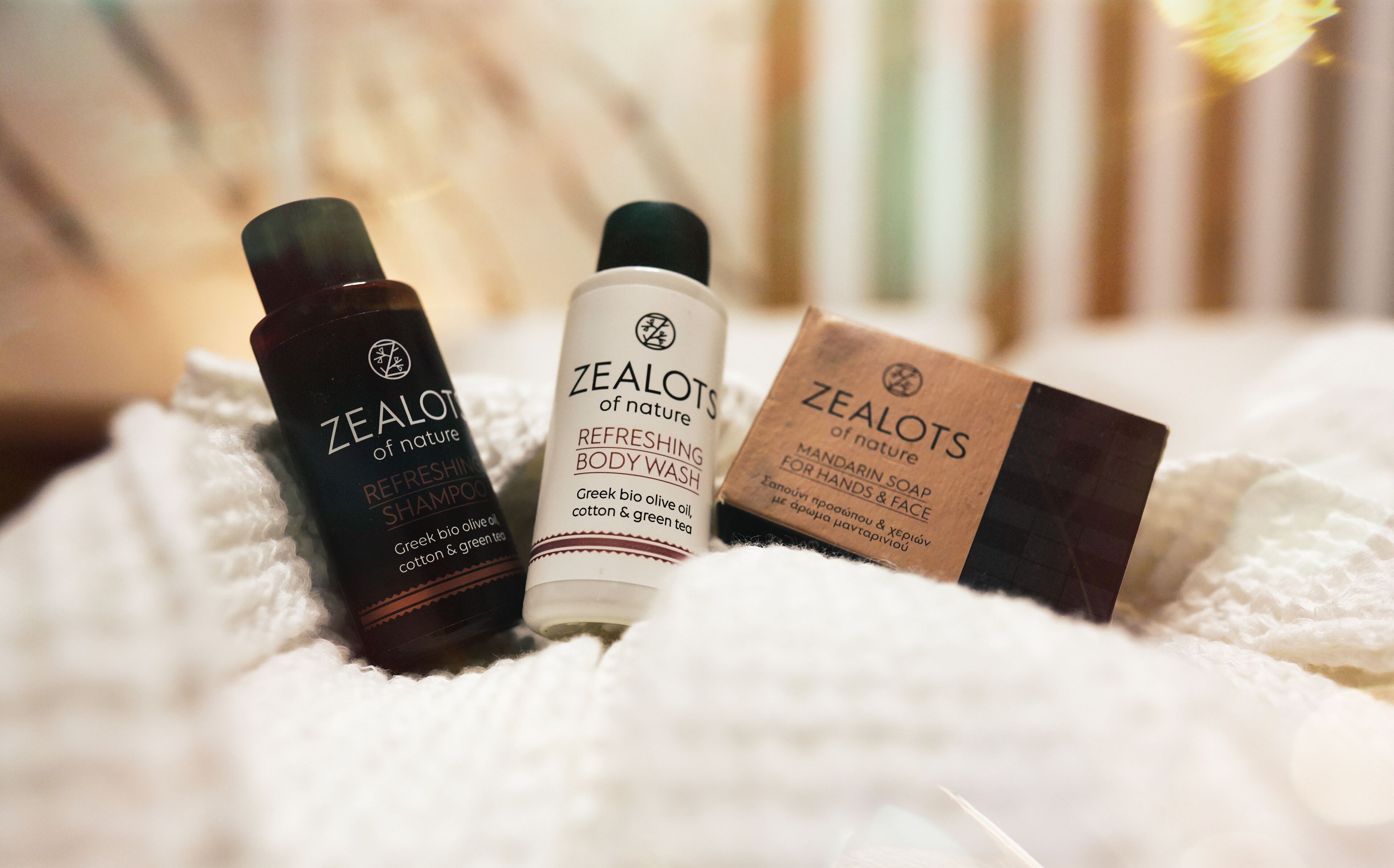 Three bottles and a box of Zealots of Nature products on a white textured surface.