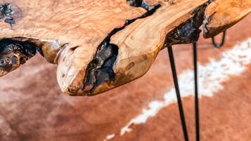 A wooden table with a unique crack design, supported by metal legs.