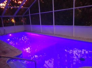 Swimmers can enjoy a clear view of the pool from all sides within the glass-enclosed area.