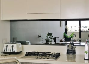Enjoy cooking in this well-equipped kitchen with a gas stove, toaster, and stainless steel countertop.