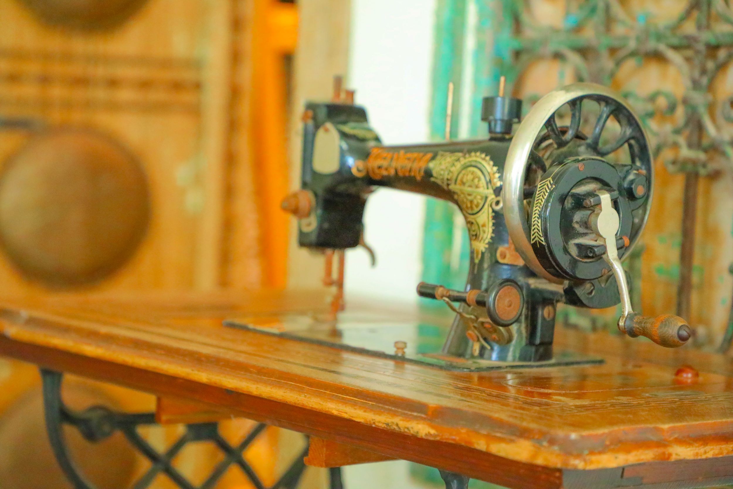 An antique sewing machine on a wooden table.