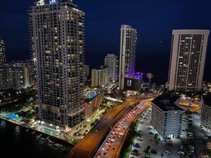 Experience the urban lifestyle at this high-rise hotel, featuring a prominent vertical structure with numerous windows and a convenient swimming pool.