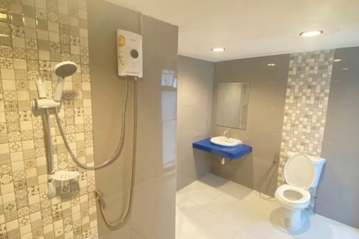 A bathroom with a shower, toilet, and sink.