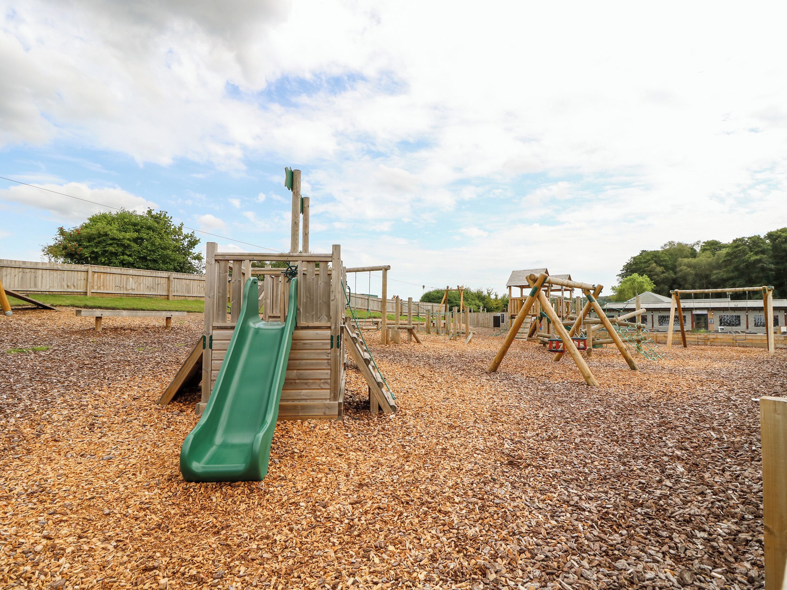 A playground with a slide, swings, and a climbing structure.