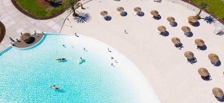 Private beach nearby, white sand, beach umbrellas, beach volleyball. Joya Vacation Club