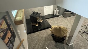 A modern interior with a staircase, a black coffee table, a white door, and a small seating area. - Lake House Barry's Bay (Barry's Bay)