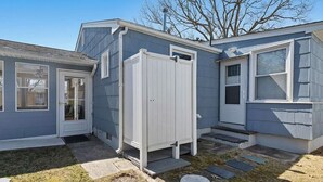 A residential property with a small shed, a door, and a window. - Cape Mindy HOT TUB Sleeps 8, Dog & EV Friendly, Outdoor Shower (Cape May)