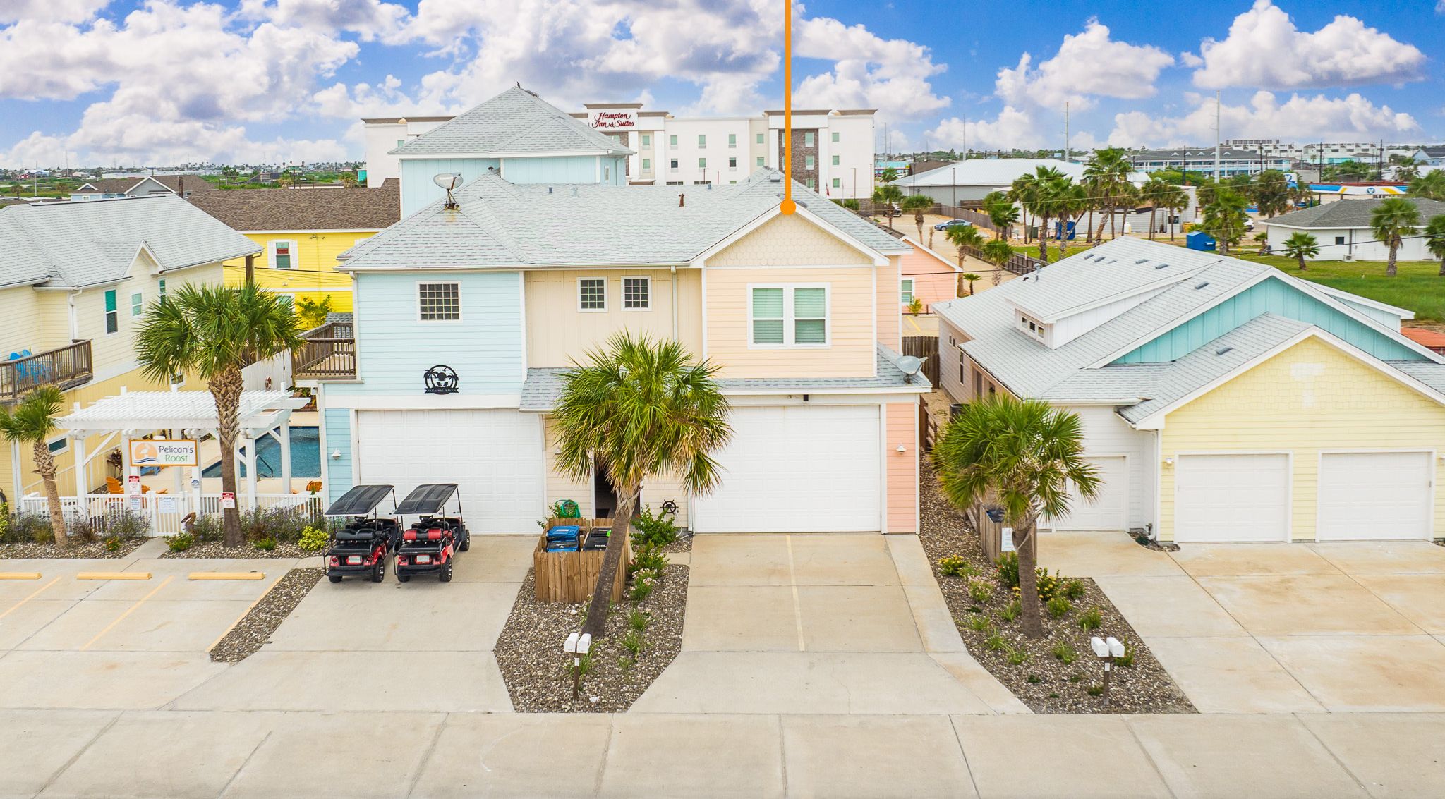 A residential area with colorful houses, including Pelican's Roost Unit 103.