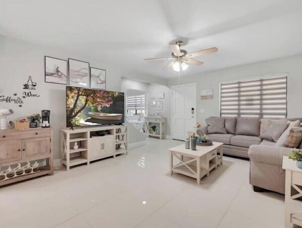 Relax in this stylish living room with a flat-screen TV, sofa, and coffee table.