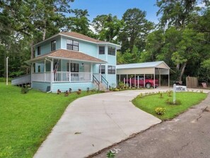 Stroll up to this charming home with a front porch and enjoy the serene surroundings.