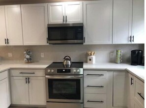 Enjoy cooking in this well-equipped kitchen with a double oven, microwave, and coffee maker.