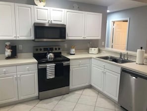 Enjoy cooking in this well-equipped kitchen with a microwave, oven, toaster, and dishwasher.