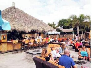 Relax in a shaded outdoor space with comfortable seating and tables.