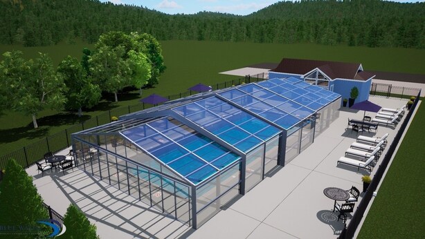 A modern glass-enclosed pool with a patio area, surrounded by a fence and trees. - Northside Cottage. Close to community pool & beaches! Sleeps 12. Fast Wi-Fi! (South Haven)