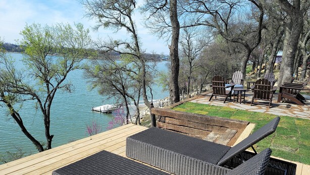 A deck with wicker furniture overlooking a lake, surrounded by trees. - The Lookout at Lakewood, Lakefront Paradise with Ultimate Entertainment, Hot Tub and Dock (Bridgeport)