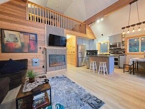 Smart TV, fireplace, books, computer monitors
