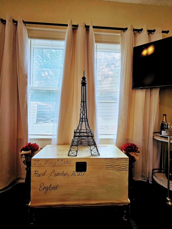A model of the Eiffel Tower on a wooden box with handwritten address in London, England.