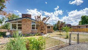 A two-story brick house with a covered patio and a fenced yard. - Grand Junction Vacation Rental w/ Patio & Grill! (Grand Junction)