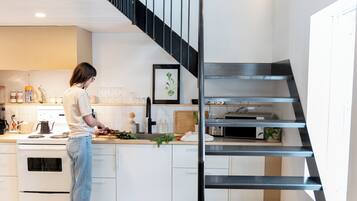 A modern kitchen with a spiral staircase.