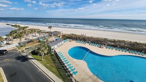 A resort with a swimming pool, beach access, and a view of the ocean.