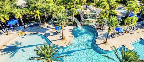 A resort with multiple swimming pools, palm trees, and a water slide.
