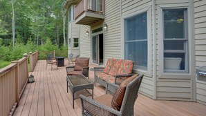 A deck with wicker furniture, a glass table, and a cushioned sofa. - Glen Spey Home w/ Grill ~ 5 Mi to Delaware River (Glen Spey)