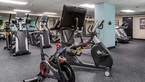 A gym with stationary bikes, treadmills, and exercise equipment.