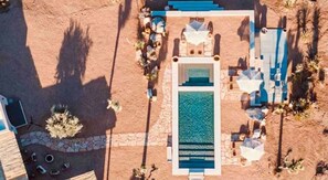 Relax by the resort's central pool surrounded by sun loungers and a covered seating area.