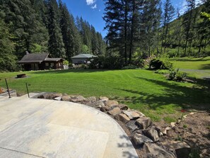 Relax in a serene outdoor space surrounded by trees and shrubs.