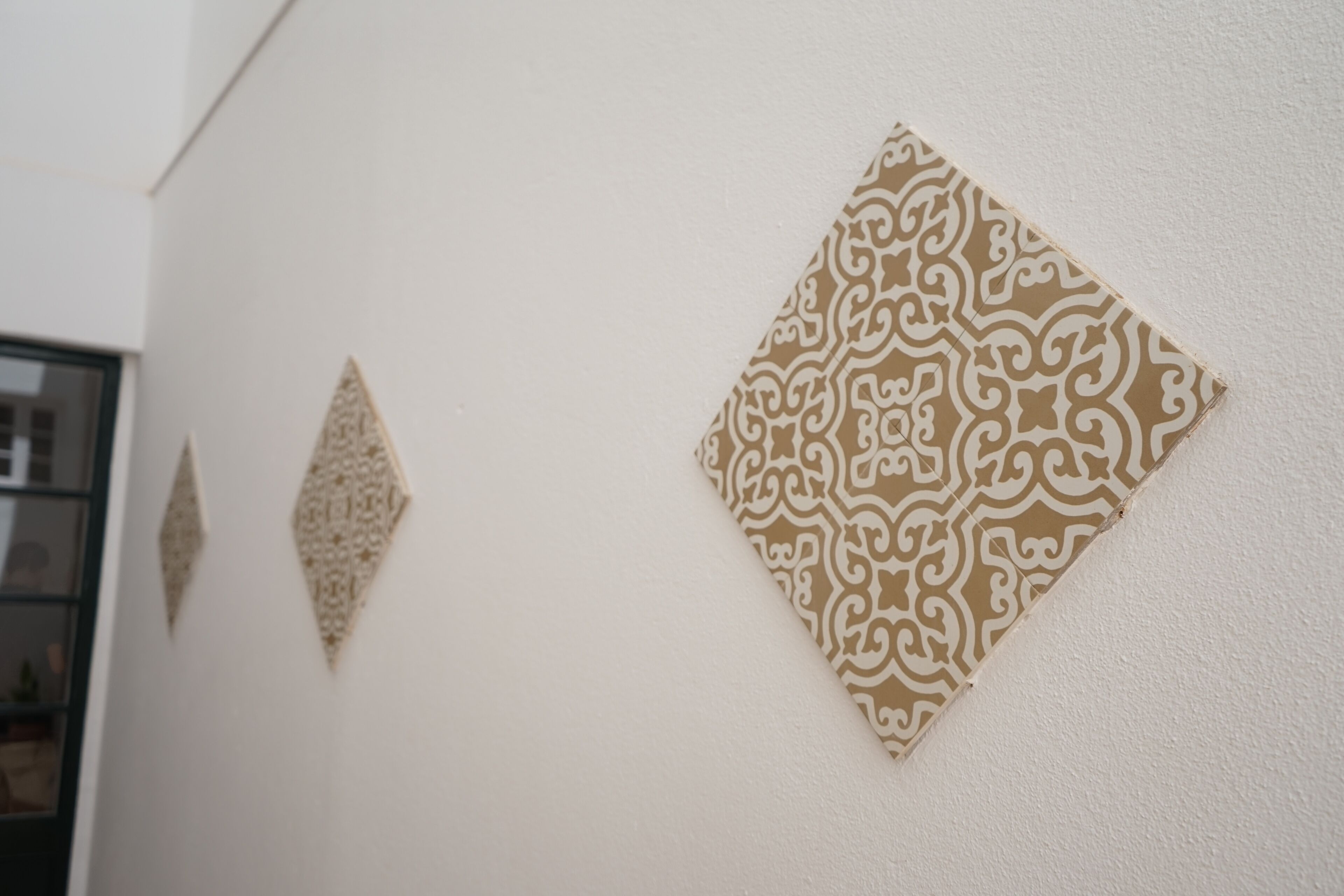 Decorative wall art with geometric and floral patterns.
