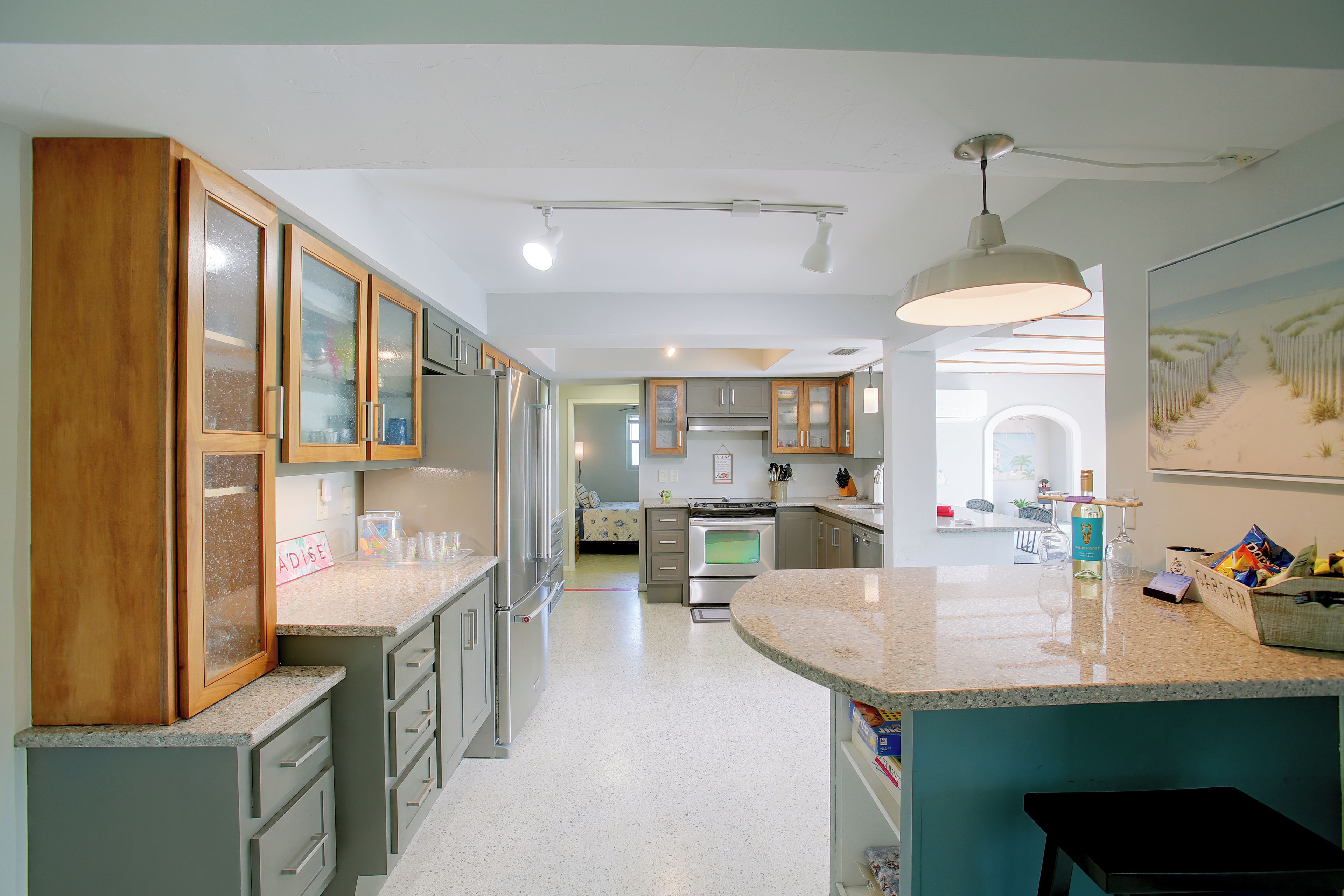 A modern kitchen with granite countertops, stainless steel appliances, and wooden cabinets.