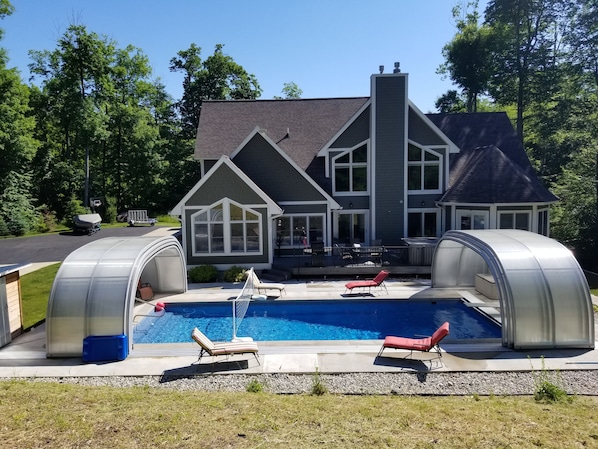 Enjoy a relaxing stay in this house with a spacious backyard, swimming pool, and covered patio area.