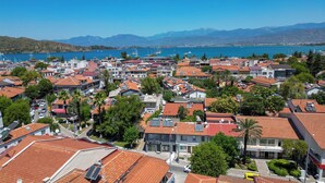 A coastal town with red-tiled roofs, a marina, and a mountain backdrop. - Central Flats Fethiye (Fethiye)