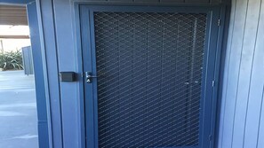 Secure entrance to a building with a diamond plate pattern door.