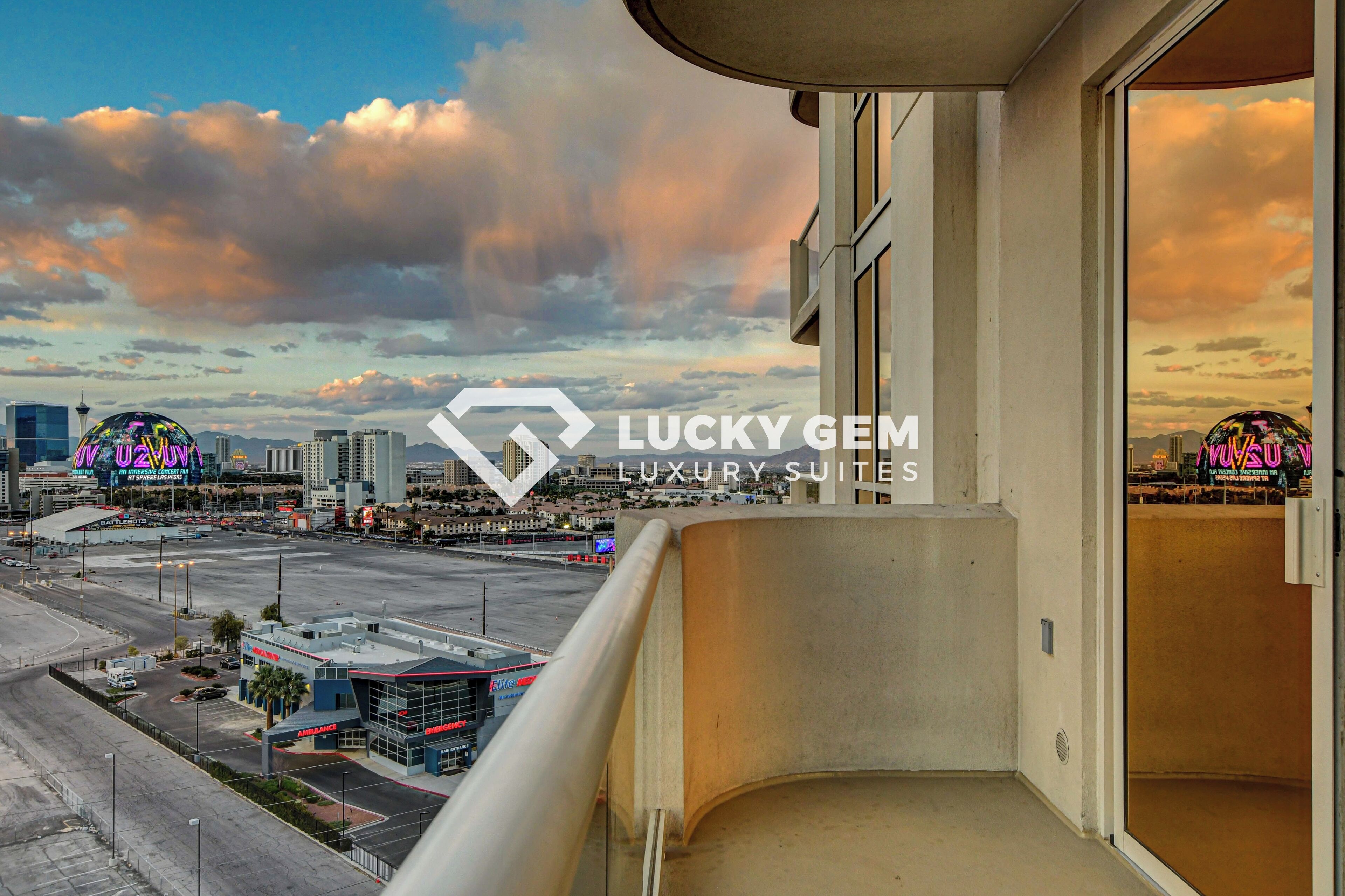 A balcony with a view of a cityscape, including a casino and a hotel.