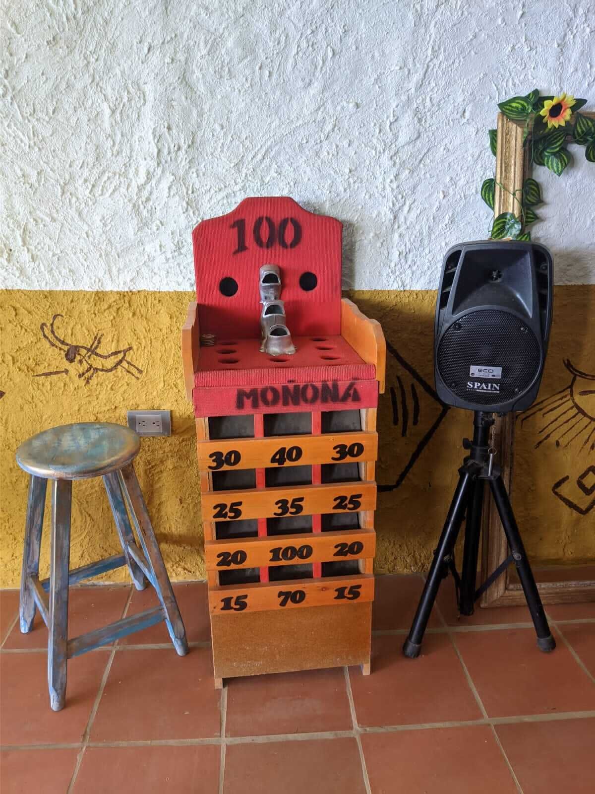 A game of MONOPOLY with a speaker and a stool beside it.