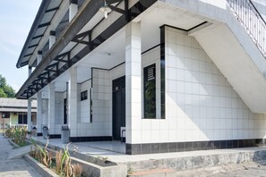 A modern building with a covered walkway and a staircase.