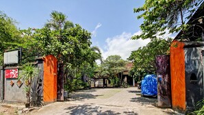 A gated entrance with a paved path leading to a building.